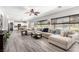 Open-concept living room featuring a view of the pool, recessed lighting, and comfortable sofa at 231 Pioneers Peak Ave, Henderson, NV 89002
