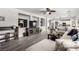 Bright living room with a TV, modern flooring, and comfortable seating flowing into the kitchen at 231 Pioneers Peak Ave, Henderson, NV 89002