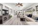 Bright living room with hardwood floors, a comfortable sectional sofa, and a ceiling fan at 231 Pioneers Peak Ave, Henderson, NV 89002