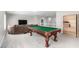 Upstairs bonus room featuring a billiard table, lounge area, and ample natural light at 231 Pioneers Peak Ave, Henderson, NV 89002