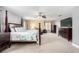 Spacious main bedroom featuring a four-poster bed, sitting area, and contemporary finishes at 231 Pioneers Peak Ave, Henderson, NV 89002