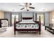 Open and airy main bedroom featuring a bed, ceiling fan, and two windows at 231 Pioneers Peak Ave, Henderson, NV 89002