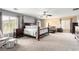 Large main bedroom with a sitting area, ceiling fan, and windows providing natural light at 231 Pioneers Peak Ave, Henderson, NV 89002