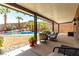 Relaxing covered patio featuring desert landscaping, a sparkling pool, and stylish outdoor seating for comfortable outdoor living at 231 Pioneers Peak Ave, Henderson, NV 89002
