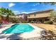 Inviting backyard pool with a covered patio, lush landscaping, and ample space for outdoor enjoyment at 231 Pioneers Peak Ave, Henderson, NV 89002