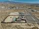 Aerial view of a desert property with generous land, including a residence and distant mountain views at 2330 Deadwood St, Pahrump, NV 89048
