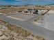The aerial shot presents a home with a circular driveway and desert landscaping with a fence along the property's edge at 2330 Deadwood St, Pahrump, NV 89048