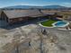 Spacious property featuring a pool, turf lawn, and large home with covered patio, ideal for leisure and relaxation at 2330 Deadwood St, Pahrump, NV 89048