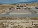 An aerial view of the single-story home reveals a circular driveway in a desert landscape, with a low fence perimeter at 2330 Deadwood St, Pahrump, NV 89048