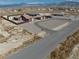 An aerial view shows a single-story home with solar panels, surrounded by desert landscape and a circular driveway at 2330 Deadwood St, Pahrump, NV 89048