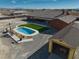 Expansive property featuring a pool, turf lawn, large home and garage, creating a private oasis at 2330 Deadwood St, Pahrump, NV 89048