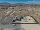 Expansive aerial view of the home with a pool and ample land with desert landscape and mountain views at 2330 Deadwood St, Pahrump, NV 89048