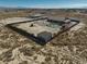 Overhead view of a backyard with pool, grass, outbuildings, all enclosed by a fence on the perimeter of the property at 2330 Deadwood St, Pahrump, NV 89048