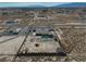 An aerial view displays a desert-landscaped property with a fenced-in area, featuring a pool and additional outbuildings at 2330 Deadwood St, Pahrump, NV 89048