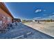 Large backyard features a storage shed, a building with a garage door, and potential for landscaping at 2330 Deadwood St, Pahrump, NV 89048