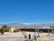 A view of a spacious backyard with shed and mountain views at 2330 Deadwood St, Pahrump, NV 89048