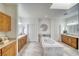Luxurious bathroom with a soaking tub, dual vanities, and elegant tile flooring at 2330 Deadwood St, Pahrump, NV 89048