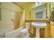 Full bathroom with shower over tub, tiled walls, and pedestal sink at 2330 Deadwood St, Pahrump, NV 89048