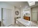 Beautiful bathroom featuring a large soaking tub, separate vanities, and natural light at 2330 Deadwood St, Pahrump, NV 89048