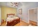 Bedroom with light wood floors, ceiling fan, and floral bedspread at 2330 Deadwood St, Pahrump, NV 89048