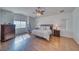Spacious bedroom with wood floors, ceiling fan, dresser and large window at 2330 Deadwood St, Pahrump, NV 89048