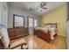Bedroom with a ceiling fan, light wood floors, and large wood dresser at 2330 Deadwood St, Pahrump, NV 89048