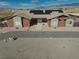 Exterior shot of the facade showing the desert landscape, architectural details, and a paved driveway at 2330 Deadwood St, Pahrump, NV 89048