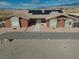 Exterior elevation of desert home with a long driveway and tasteful landscaping in a natural setting at 2330 Deadwood St, Pahrump, NV 89048