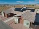 Modern exterior view with striking roof solar panels, landscaping, and a well-maintained yard at 2330 Deadwood St, Pahrump, NV 89048