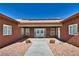 Inviting front entrance with double doors, xeriscaping, and desert-style planters at 2330 Deadwood St, Pahrump, NV 89048