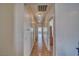 Long hallway with wood floors and recessed lighting leading to bedrooms at 2330 Deadwood St, Pahrump, NV 89048