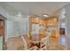 Eat-in kitchen features wood cabinets and a breakfast nook with a round wood table and rug at 2330 Deadwood St, Pahrump, NV 89048
