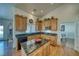 Kitchen featuring island, tile countertops, and oak cabinets at 2330 Deadwood St, Pahrump, NV 89048