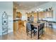 Open kitchen featuring wood cabinets, granite countertops, and an island with seating at 2330 Deadwood St, Pahrump, NV 89048