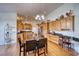Charming kitchen with wood cabinetry, a central island, and ample countertop space at 2330 Deadwood St, Pahrump, NV 89048