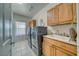 Spacious laundry room with washer, dryer, tile floors, cabinets and sink at 2330 Deadwood St, Pahrump, NV 89048