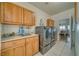 Spacious laundry room with washer, dryer, tile floors, countertops and sink at 2330 Deadwood St, Pahrump, NV 89048