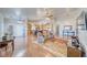 Large living room with wood floors seamlessly connecting to an open kitchen at 2330 Deadwood St, Pahrump, NV 89048