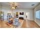 Spacious living room featuring a fireplace, a ceiling fan, and wood flooring at 2330 Deadwood St, Pahrump, NV 89048