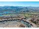 Stunning aerial view of the residential neighborhood with golf course, lake, and mountains in the background at 26 Via Vasari # 204, Henderson, NV 89011