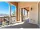 Spacious outdoor balcony featuring stately columns and wrought iron railings with views at 26 Via Vasari # 204, Henderson, NV 89011