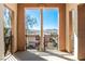 Outdoor balcony with view of neighborhood featuring wrought iron railings and classic columns at 26 Via Vasari # 204, Henderson, NV 89011