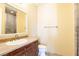 Bathroom featuring vanity with sink and granite countertop, mirror, and enclosed shower at 26 Via Vasari # 204, Henderson, NV 89011