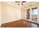 Bright bedroom with wood floors, ceiling fan, and sliding doors to a balcony with mountain views at 26 Via Vasari # 204, Henderson, NV 89011
