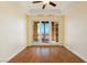 Bedroom boasts hardwood floors, modern ceiling fan, and glass patio doors with neighborhood views at 26 Via Vasari # 204, Henderson, NV 89011