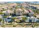 Aerial image of clubhouse featuring manicured front garden with sculpture and palm trees at 26 Via Vasari # 204, Henderson, NV 89011