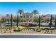 Clubhouse aerial shot featuring elegant sculpture, palm trees and lush desert landscaping at 26 Via Vasari # 204, Henderson, NV 89011