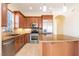 A gourmet kitchen features stainless steel appliances, granite countertops, and custom wood cabinets at 26 Via Vasari # 204, Henderson, NV 89011