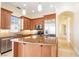 A gourmet kitchen features stainless steel appliances, granite countertops, and custom wood cabinets at 26 Via Vasari # 204, Henderson, NV 89011