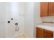 Practical laundry room with functional cabinetry, utility sink and connections for washer and dryer at 26 Via Vasari # 204, Henderson, NV 89011
